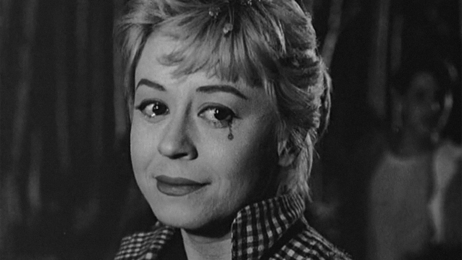 A black-and-white close-up of Cabiria with tears in her eyes